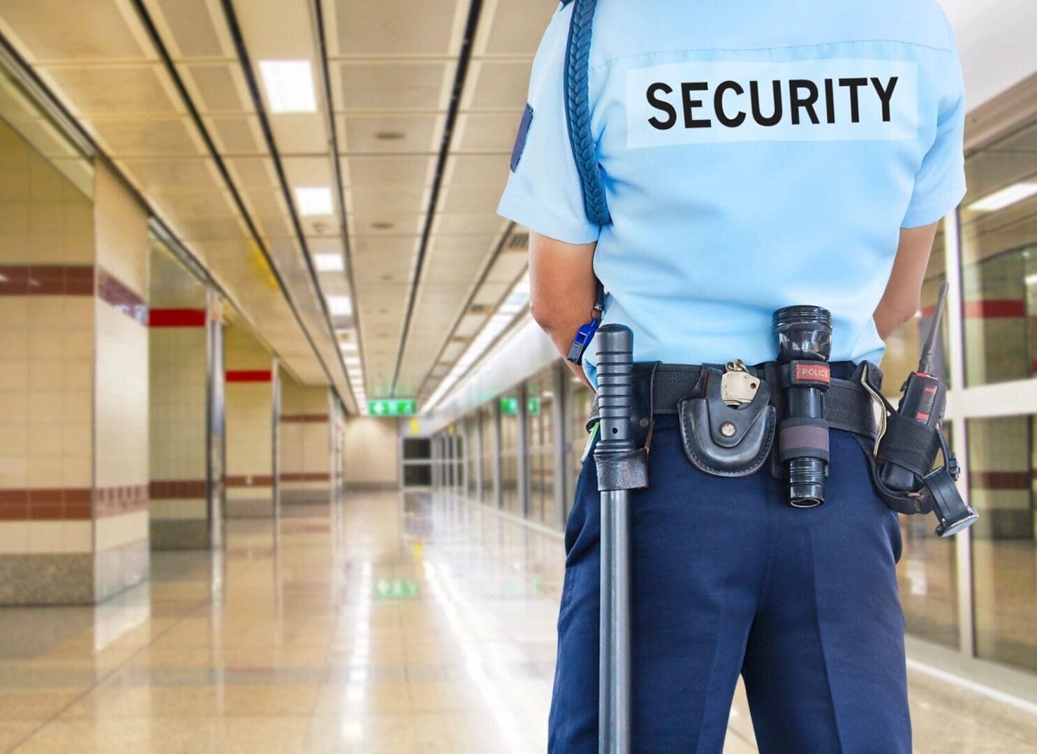 Warehouse personnel being inspected by security guards upon entry.
