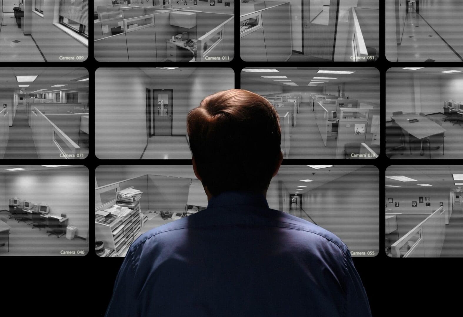 Security personnel checking movements on a warehouse CCTV monitor.