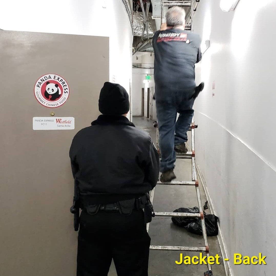 Security guards inspecting goods and items inside a warehouse.