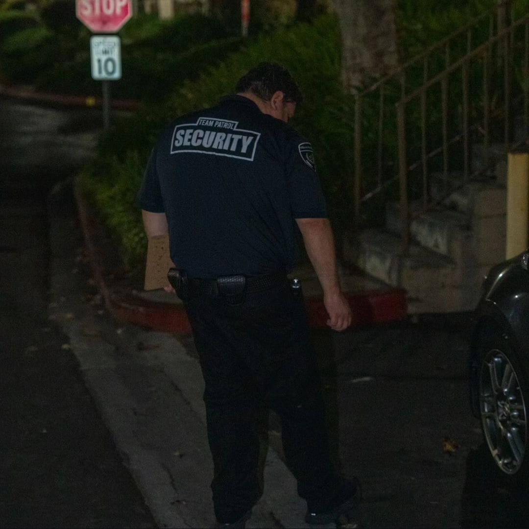 Security guard in black uniform at night.