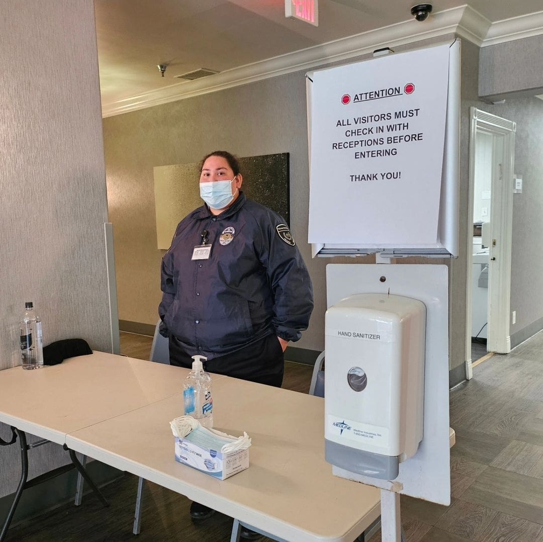 Security guard at check-in desk.